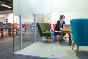 Ola working on a laptop in an office