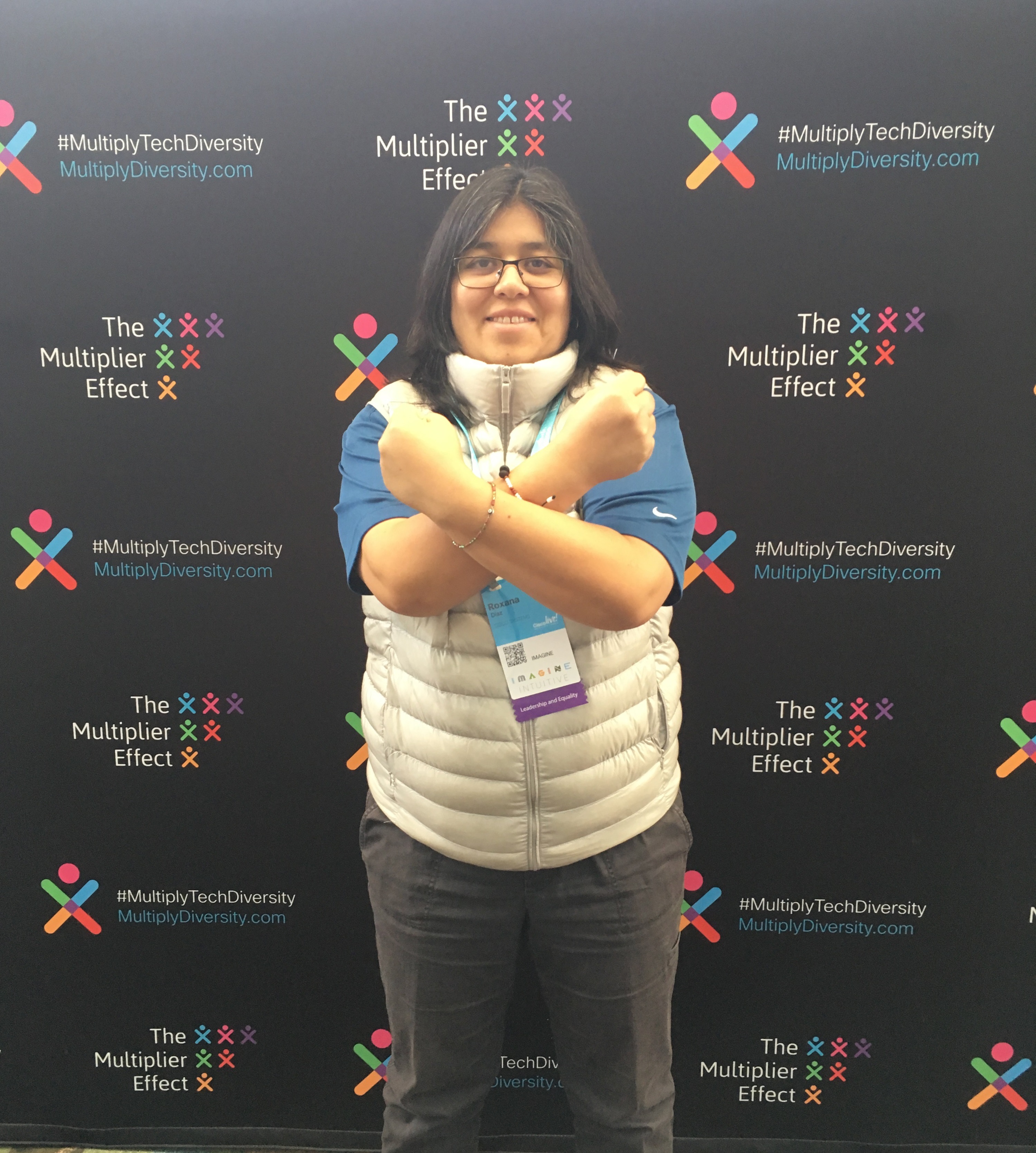 Roxana posing in front of a backdrop for #MultiplyTechDiversity.