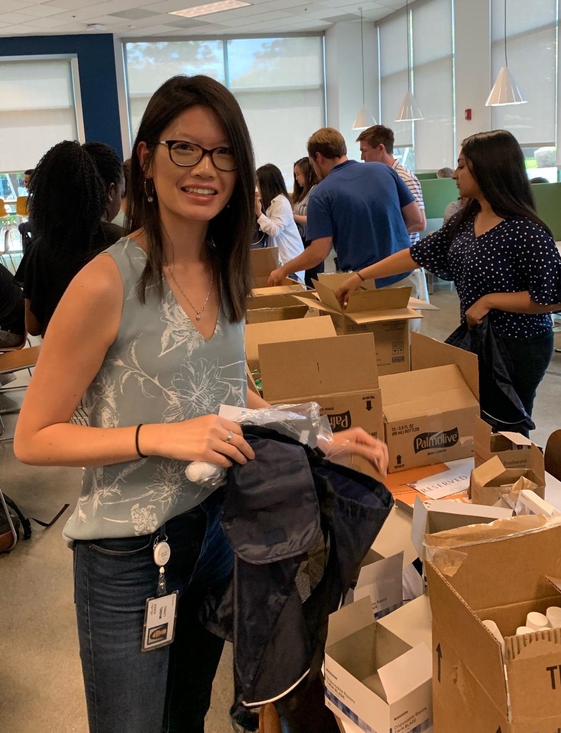 Mabel smiling as she assembles hygiene care packages for local food pantries.