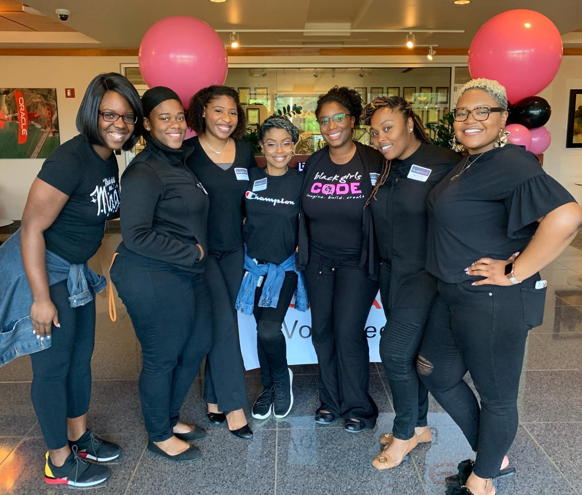 Crystal smiling alongside 6 of her Black Girls Code peers.