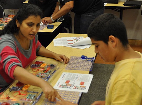A Cisco volunteer in RTP mentors a student at the launch event