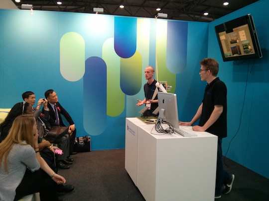 Student volunteers share live demonstrations with booth visitors