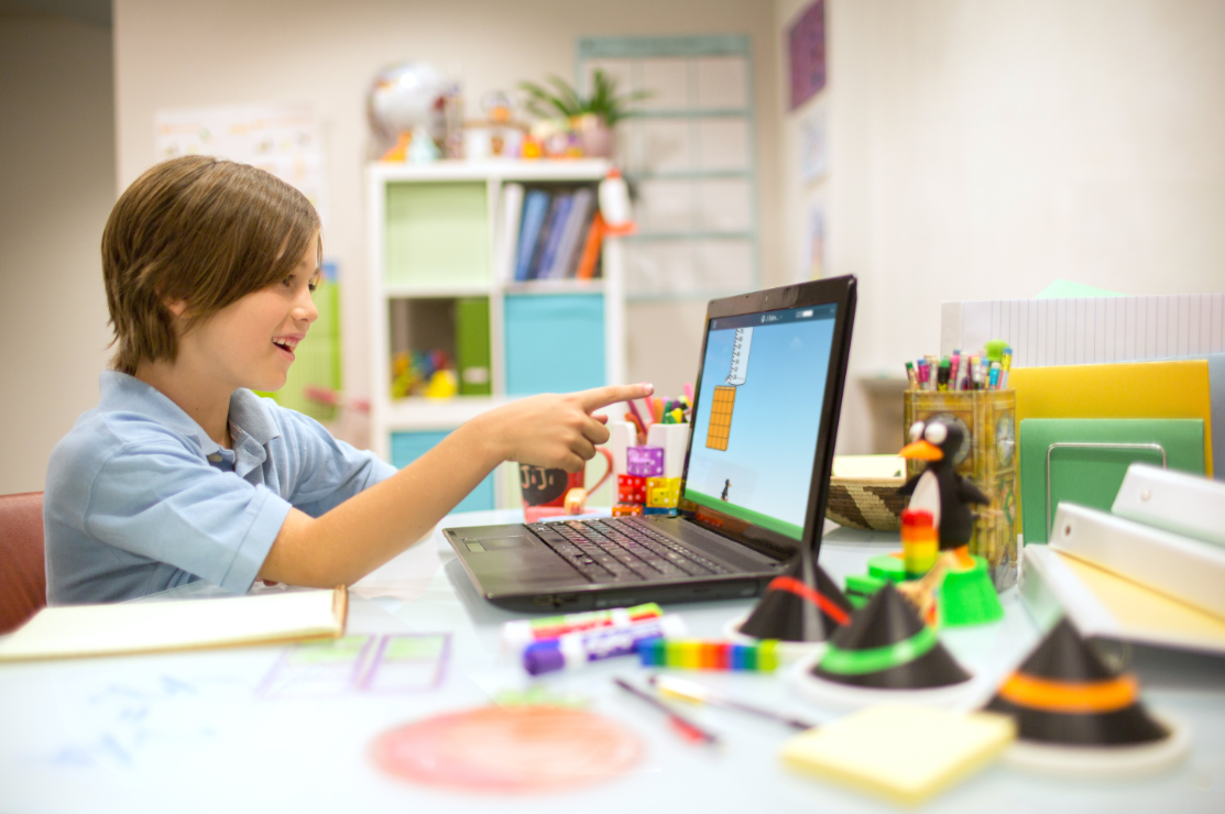 A student playing an ST Math game on a laptop