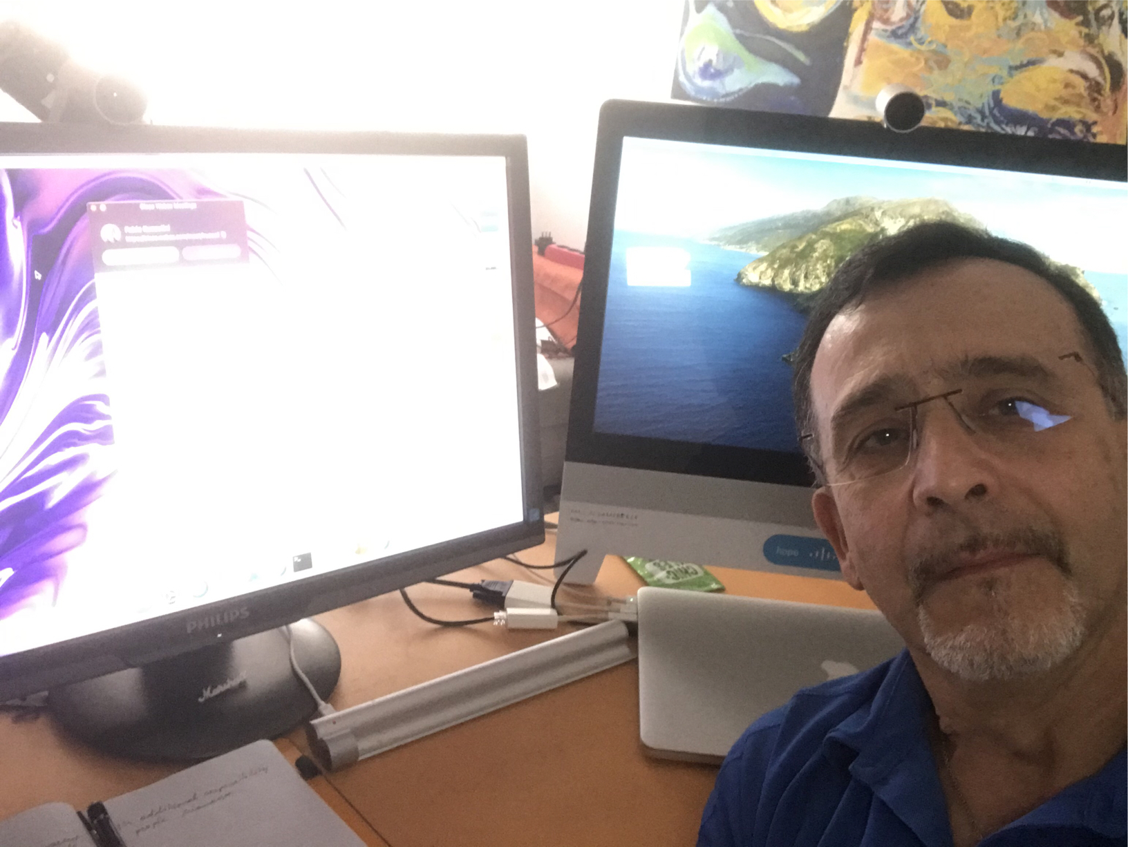 Fabio sits in front of two monitors.