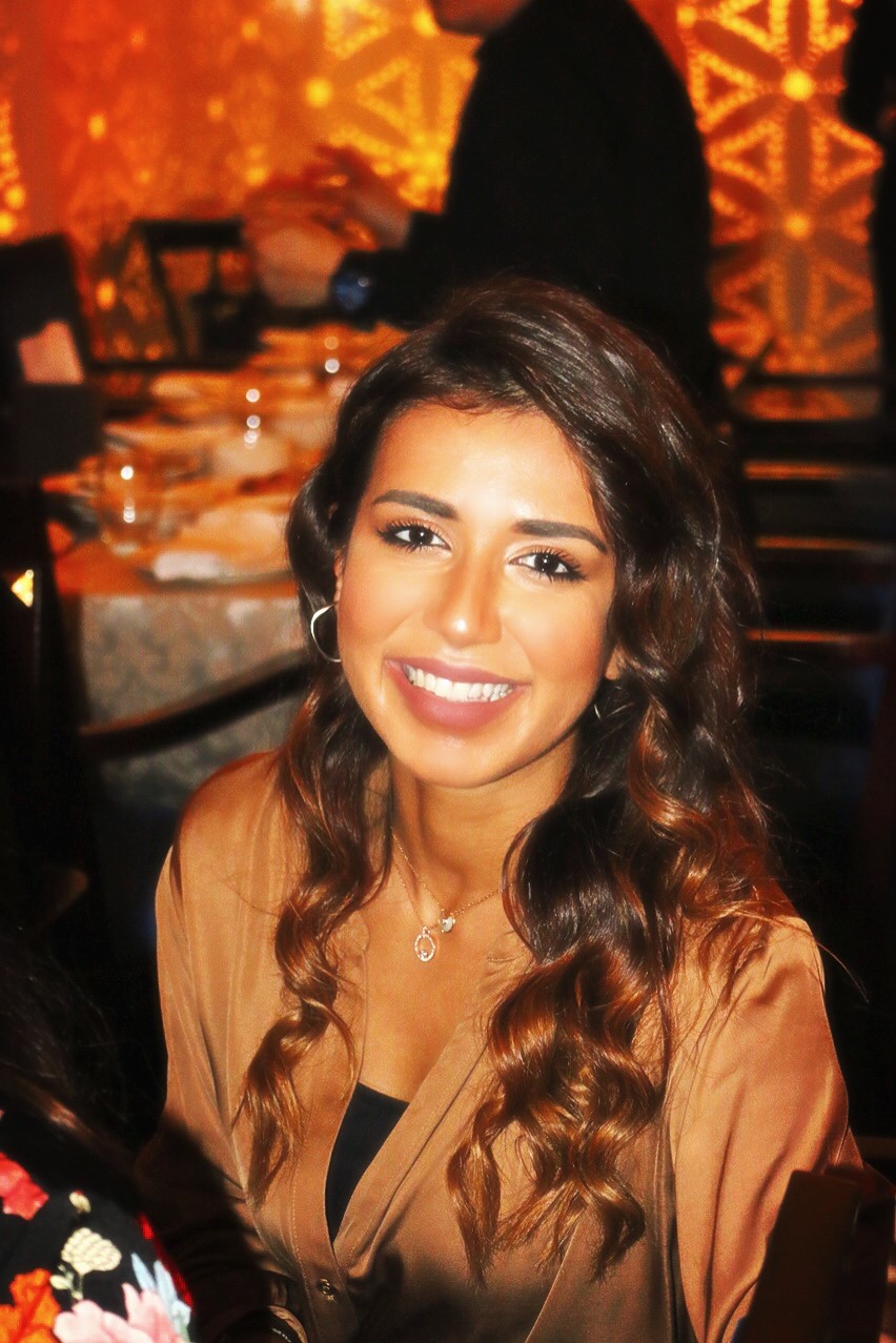 Eman AlTamimi smiling at a dinner.