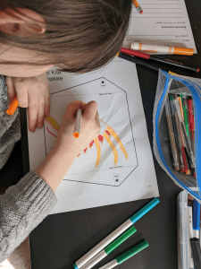 A student works on a kite project designed to teach principles of aerodynamics