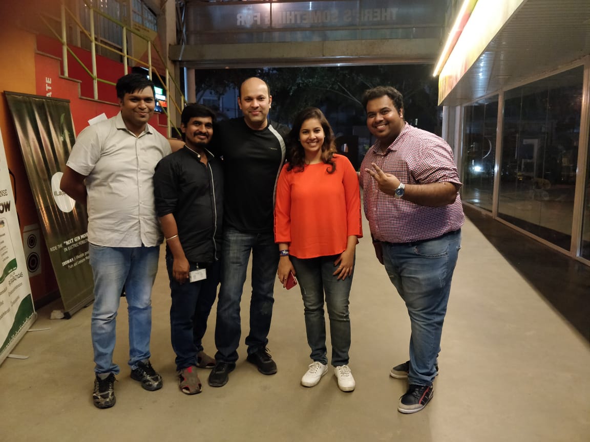 Nikita smiles with 4 of her colleagues. 