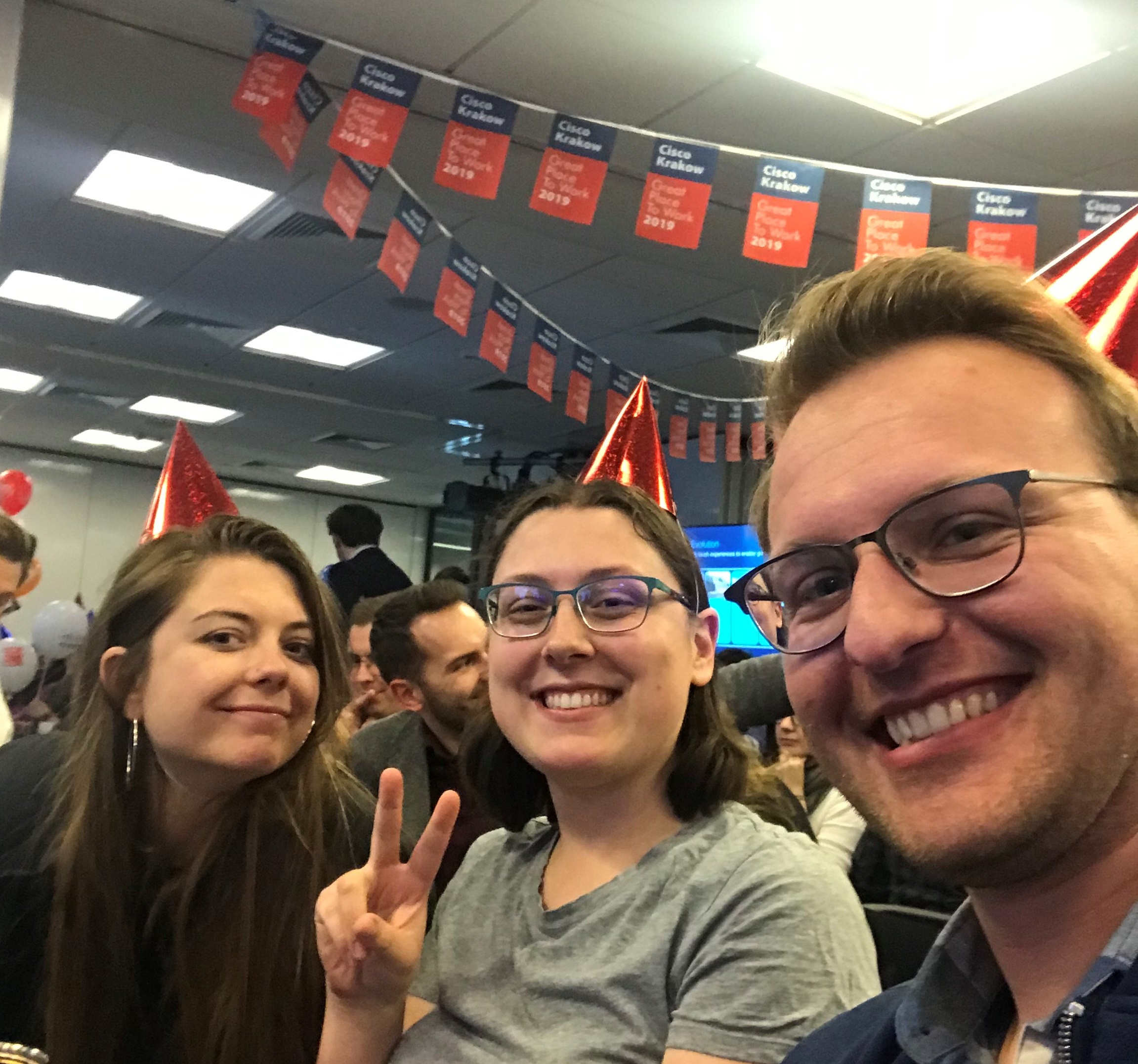 David and his peers with party hats on celebrate at Cisco Krakow.