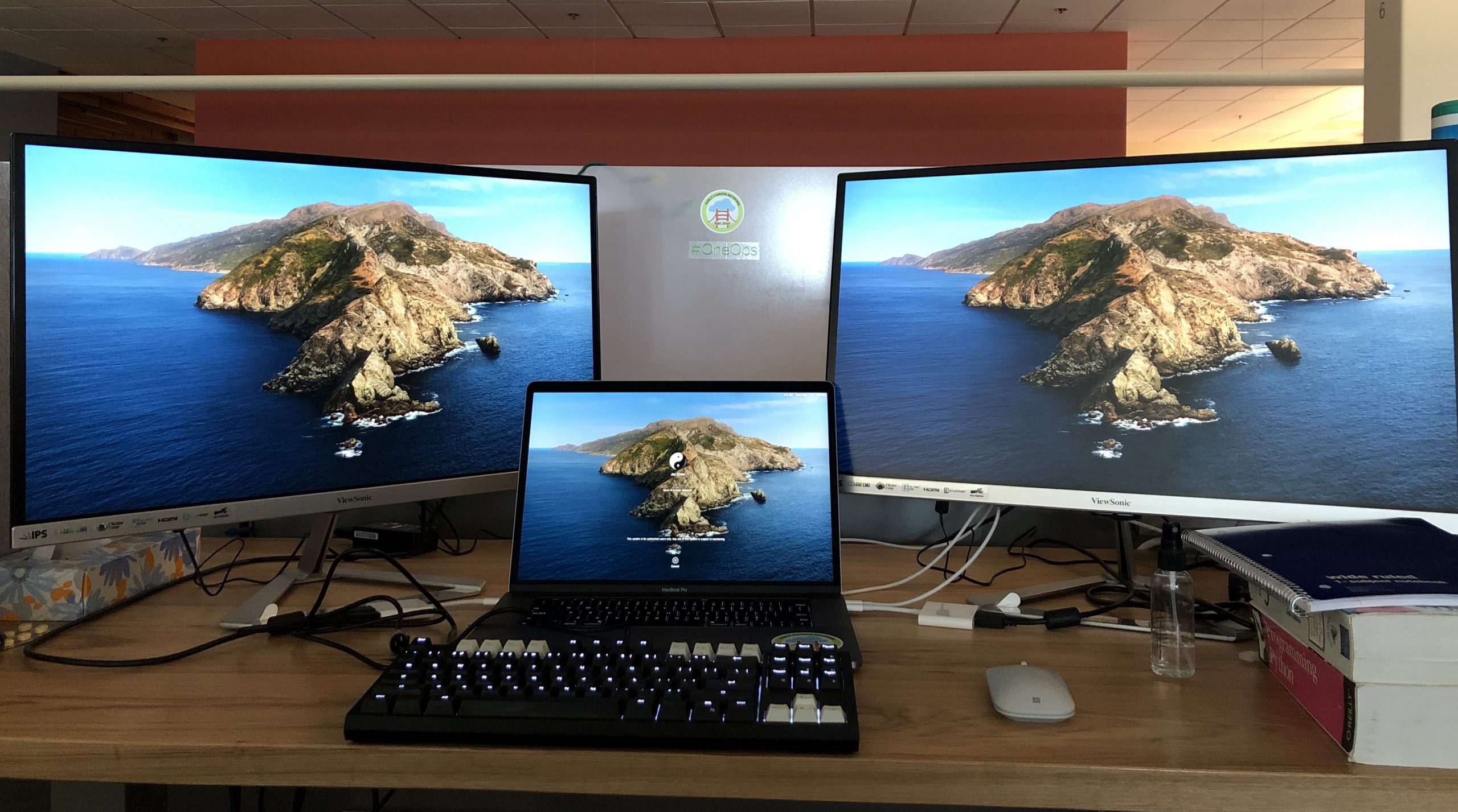 Jay's desk at work with 2 external monitors and his laptop in the middle.