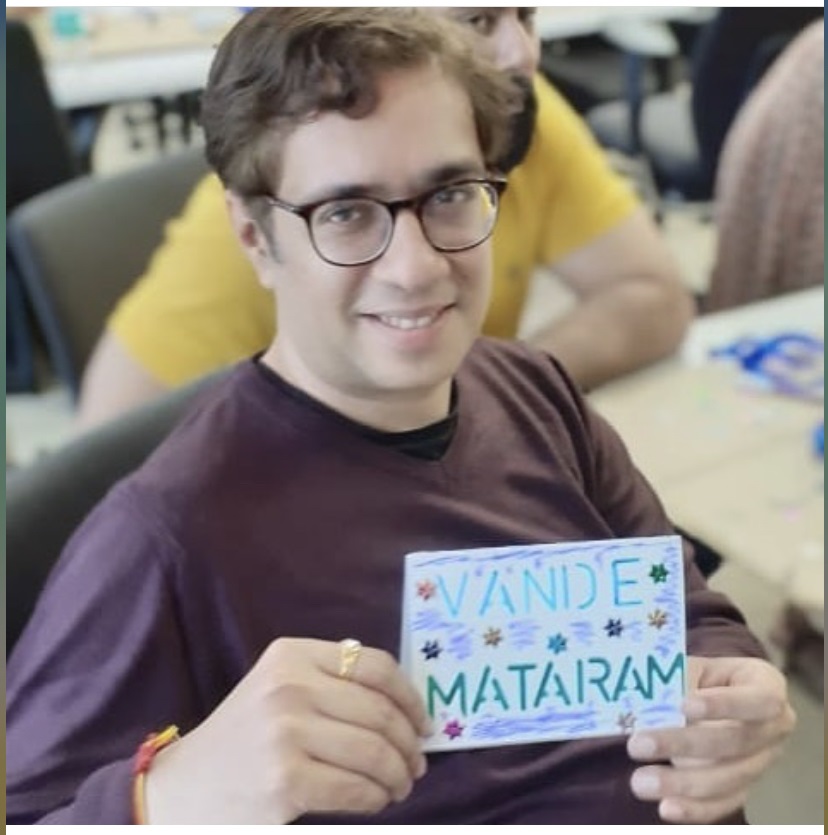 Vivasvan holds a hand colored sign that says "Vande Mataram"