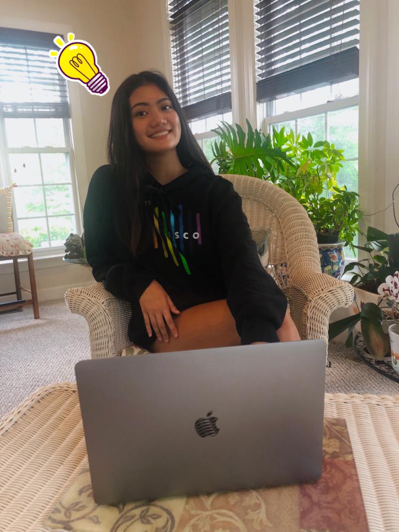 Cat in Cisco sweatshirt behind MacBook.