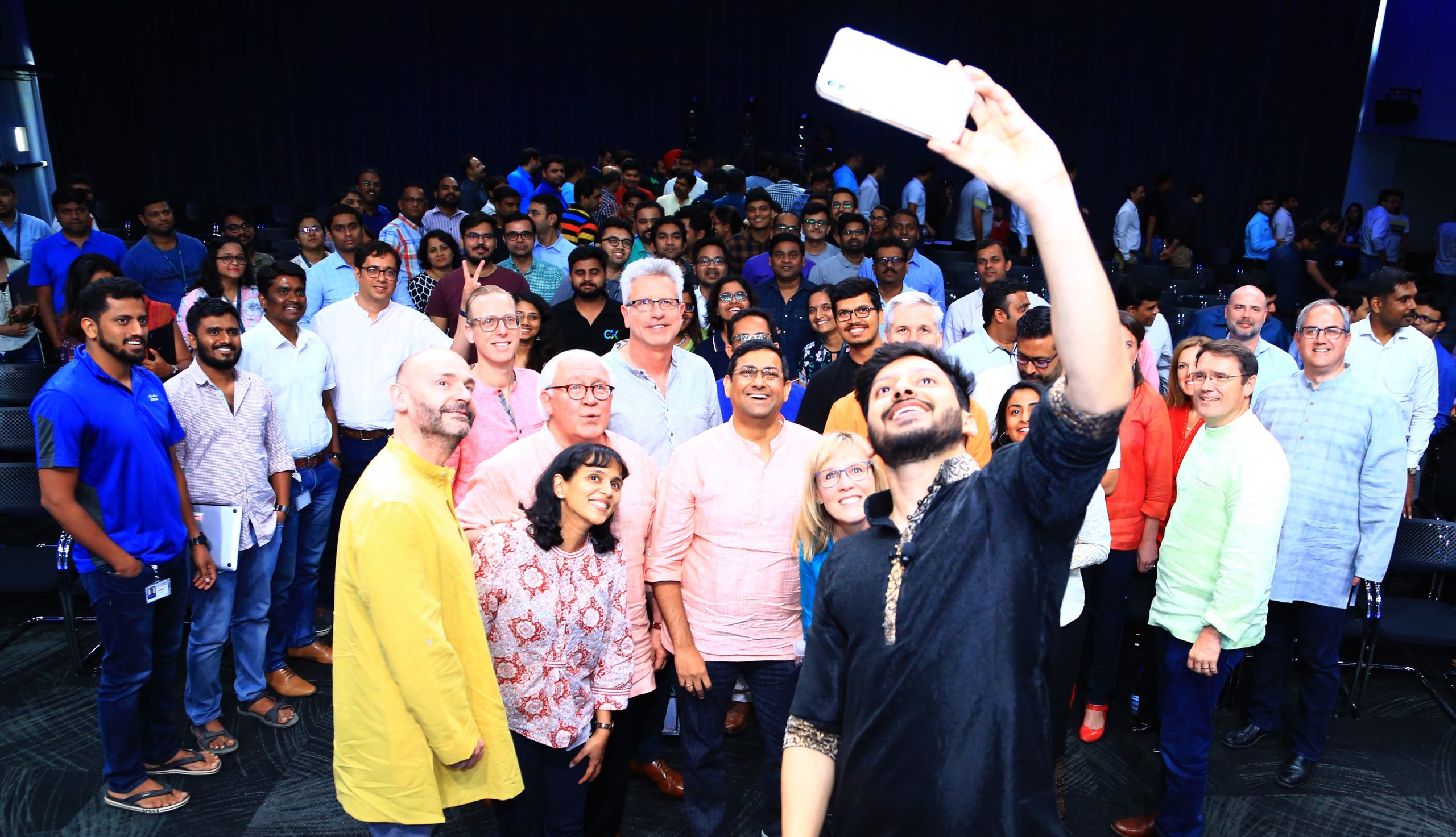 Rahul taking a selfie with a large group of people.