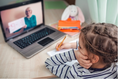 child sitting at a computer doing distance learning