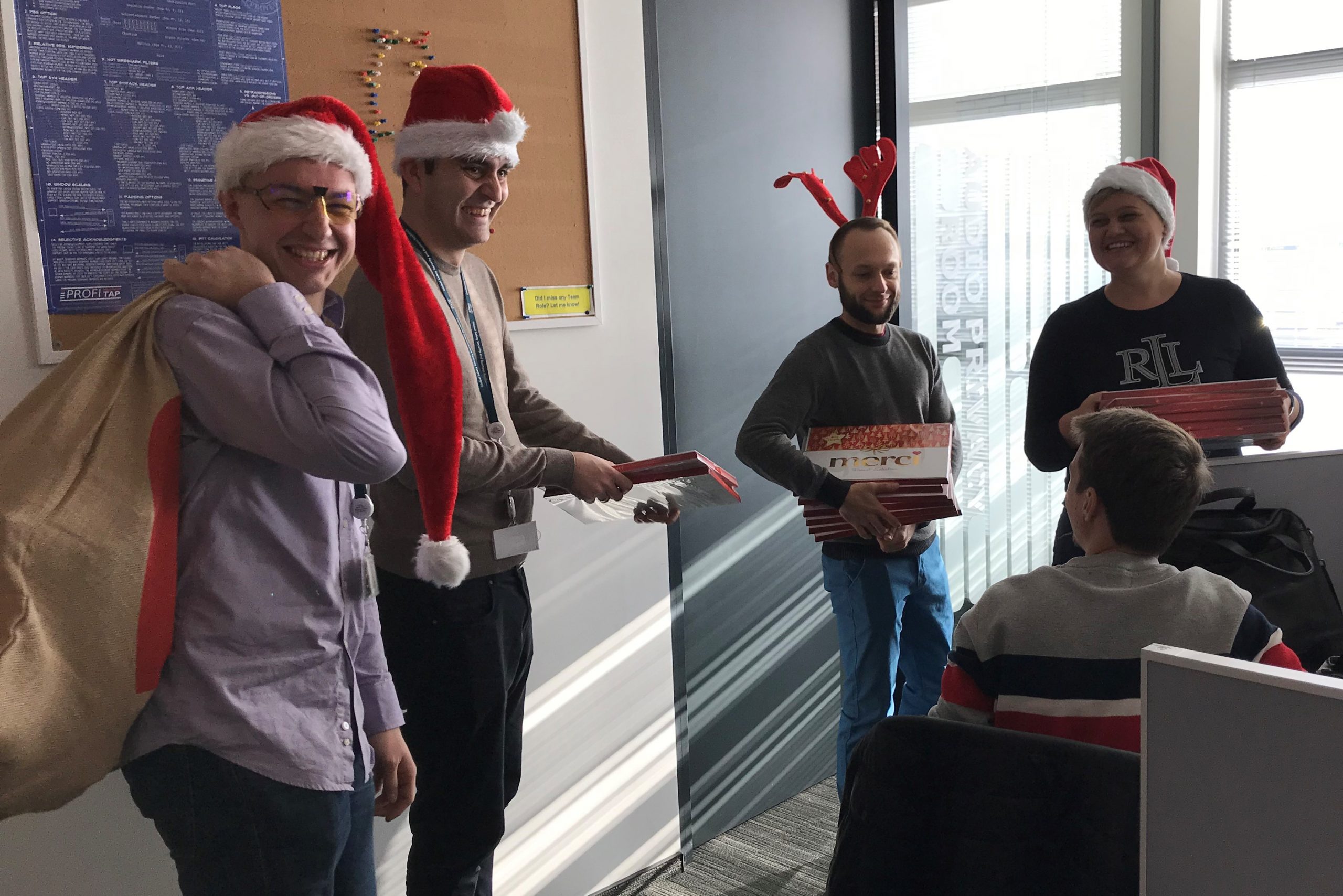 Danuta and co-workers in Santa hats.