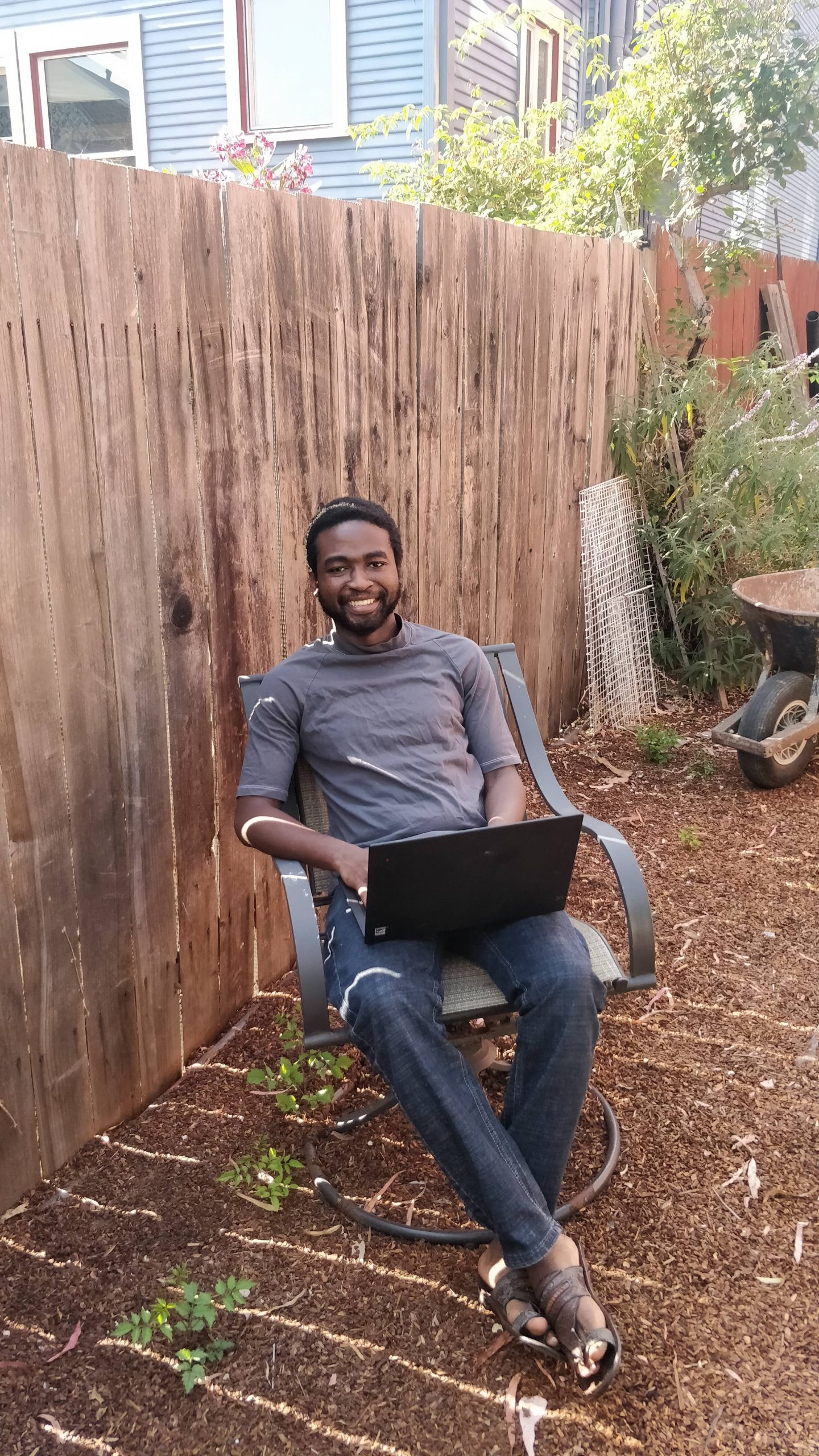 Faith sitting in backyard.