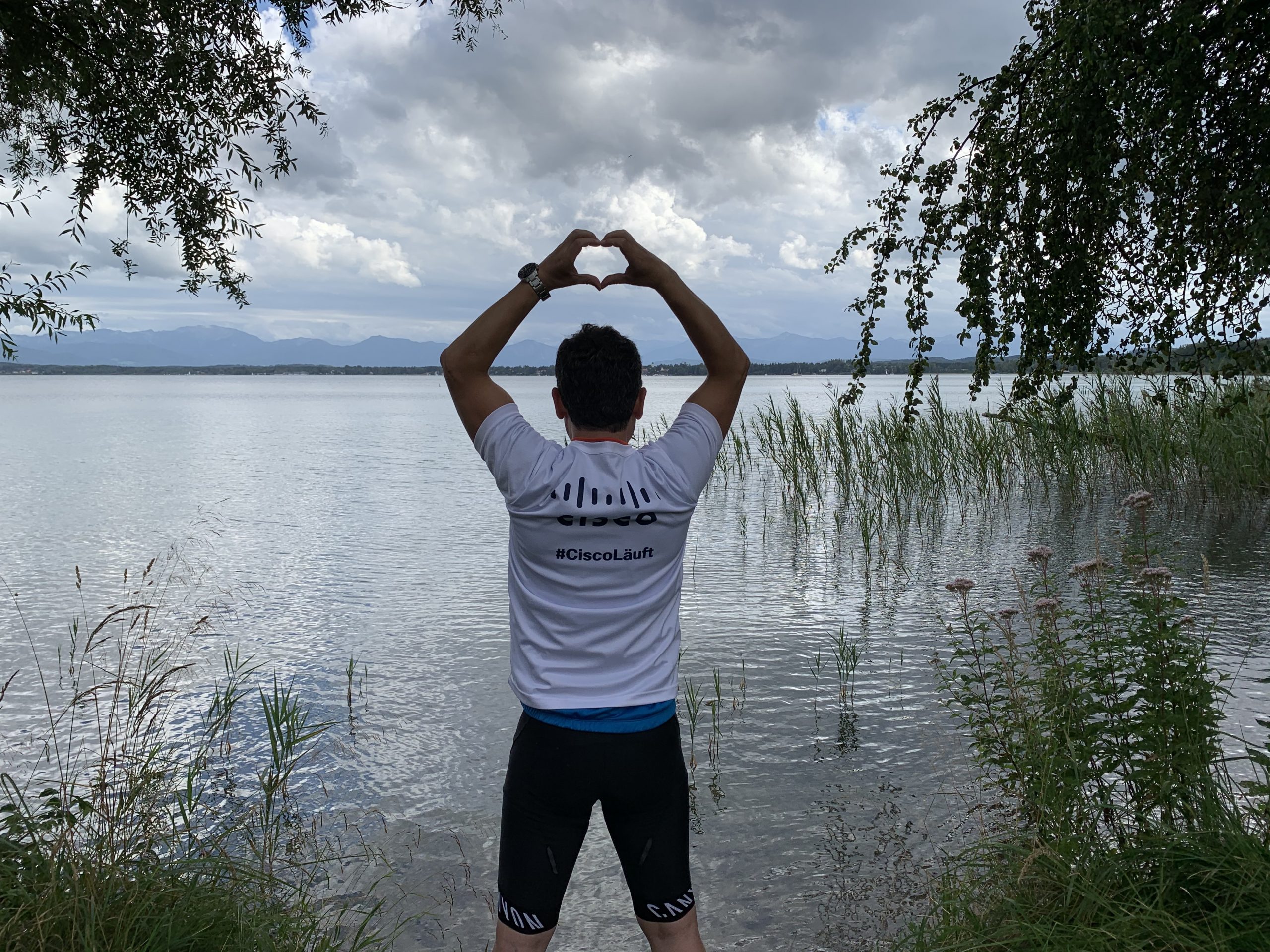 Ahmet in front of water in his Cisco Lauft shirt 