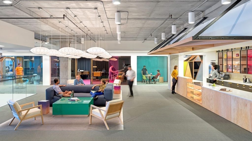 Open space with with couch and chairs and break out rooms 