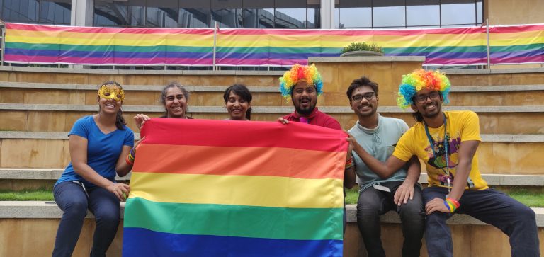 People holding a PRIDE flag
