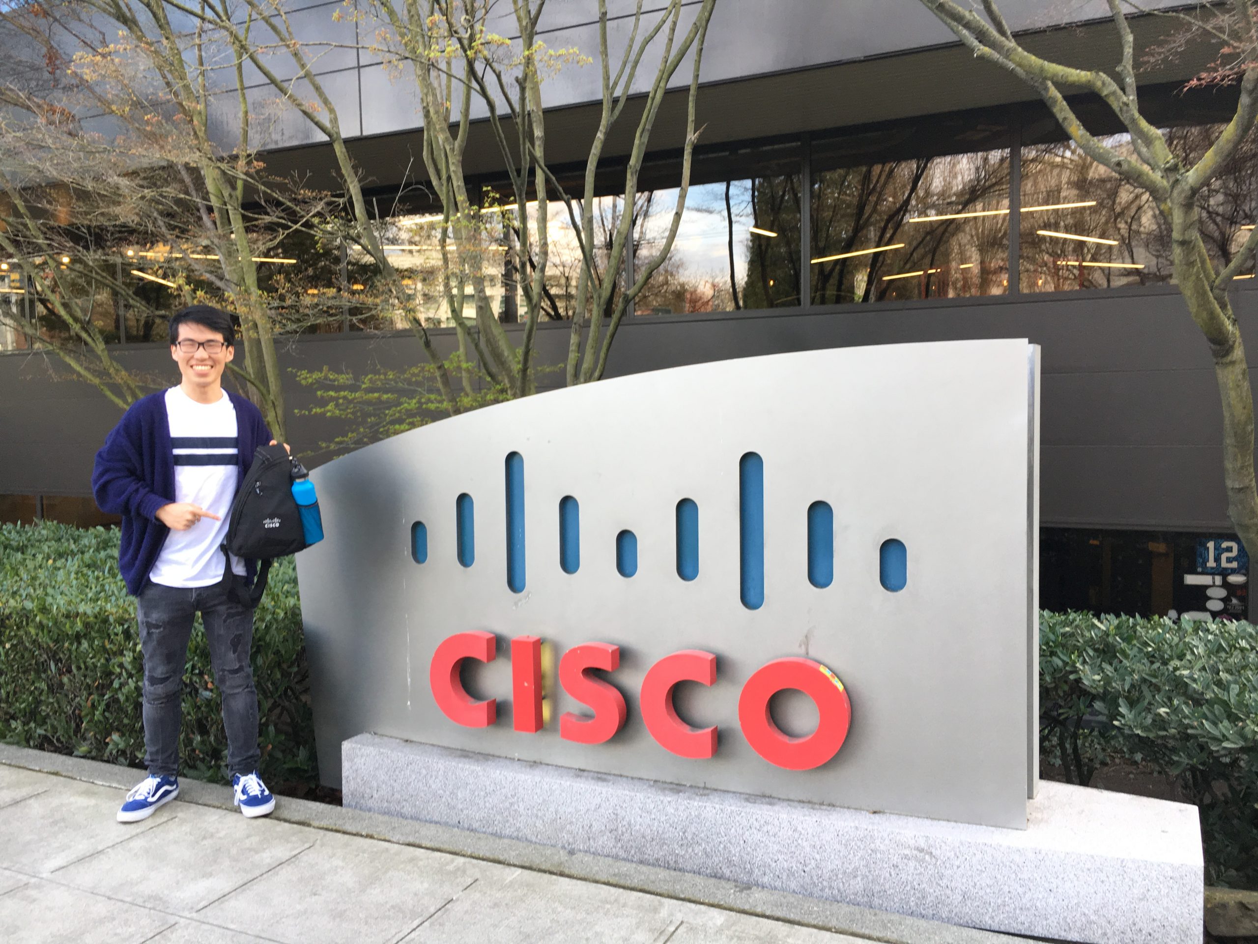 Bryce in front of Cisco sign.
