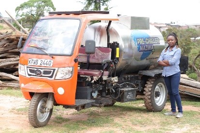 Emmastella with one of Savanna Circuit Tech's solar milk chillers