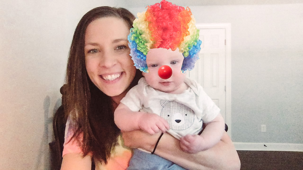 Jen and her son pose for a photo. Her son has a clown face filter on.