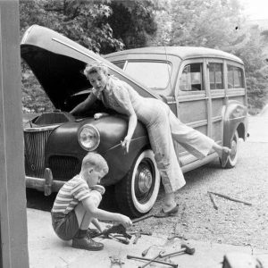 ord Super Deluxe "Woodie" station wagon, first introduced late 1940. Women & boy making repairs