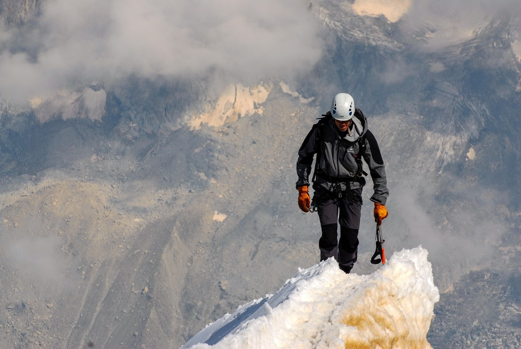 Alex backpacking on a snowy peak.