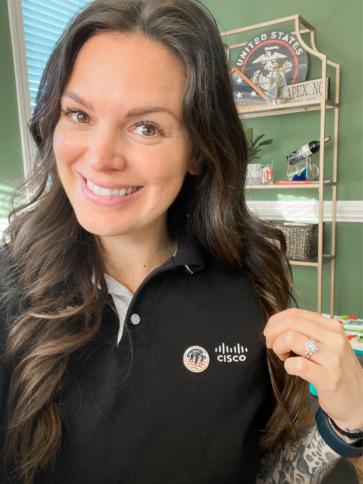Chelsea taking a selfie in her Cisco sweater with her VETS pin