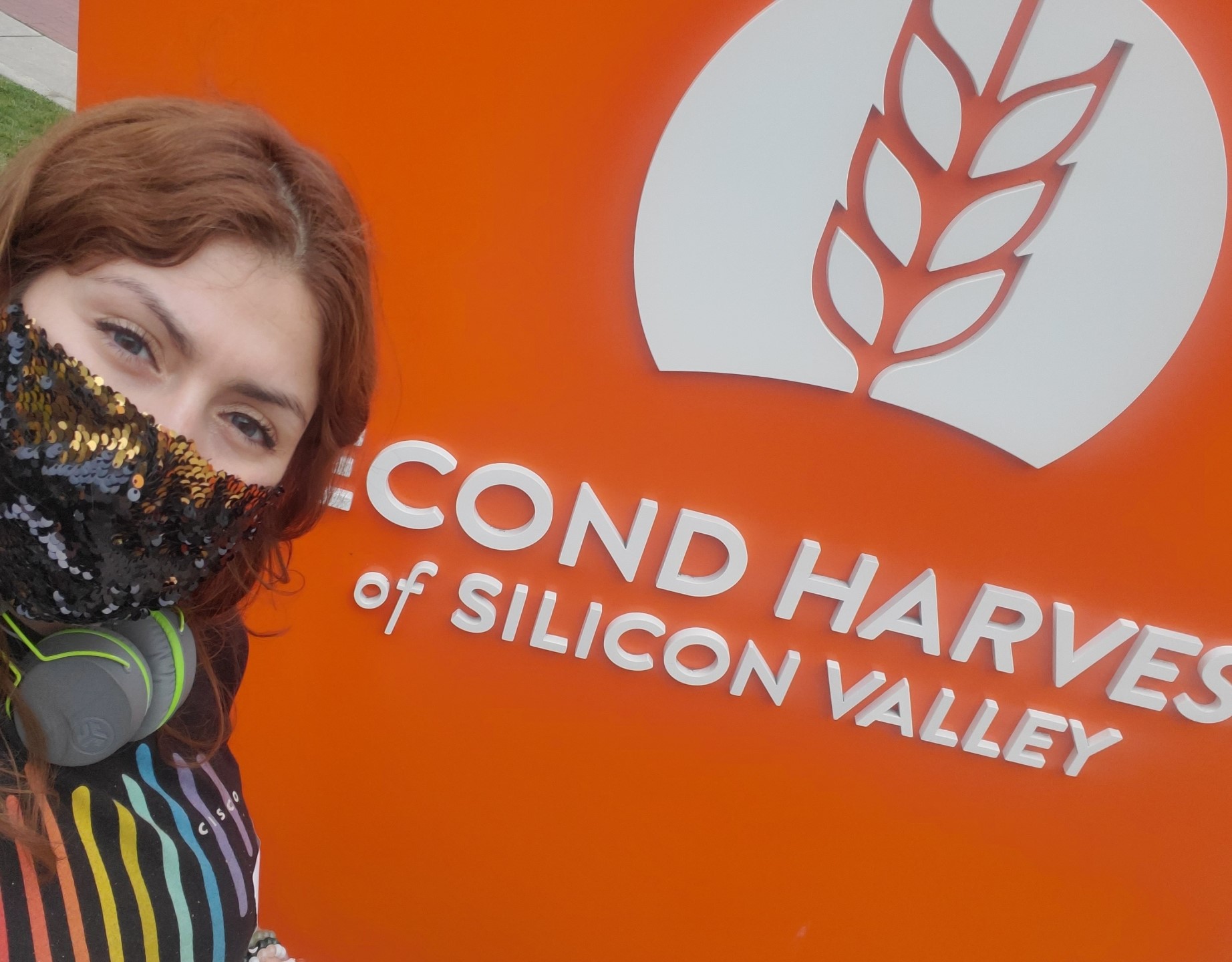 Pelin in front of Second Harvest Silicon Valley sign.