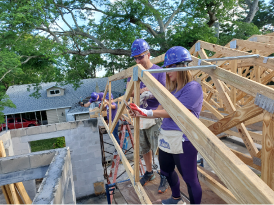 Cisco employees building a house together 