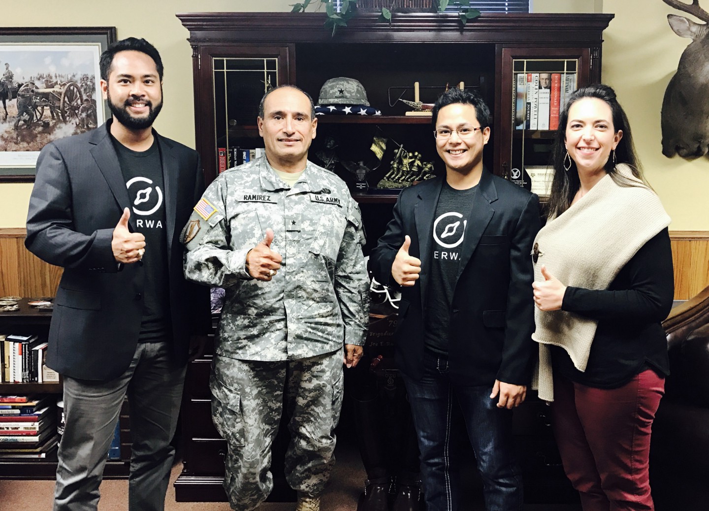 Josh giving a thumbs up next to co-workers