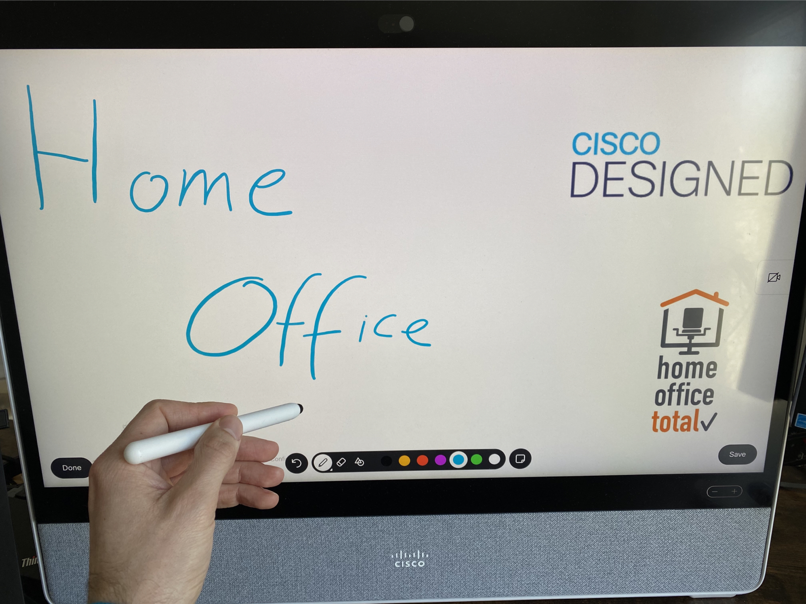 Marwin writing "Home Office" on a Cisco Board.