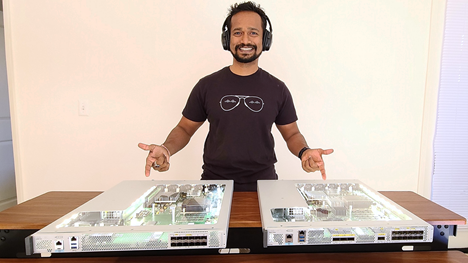 Sumant standing pointing at Catalyst servers.