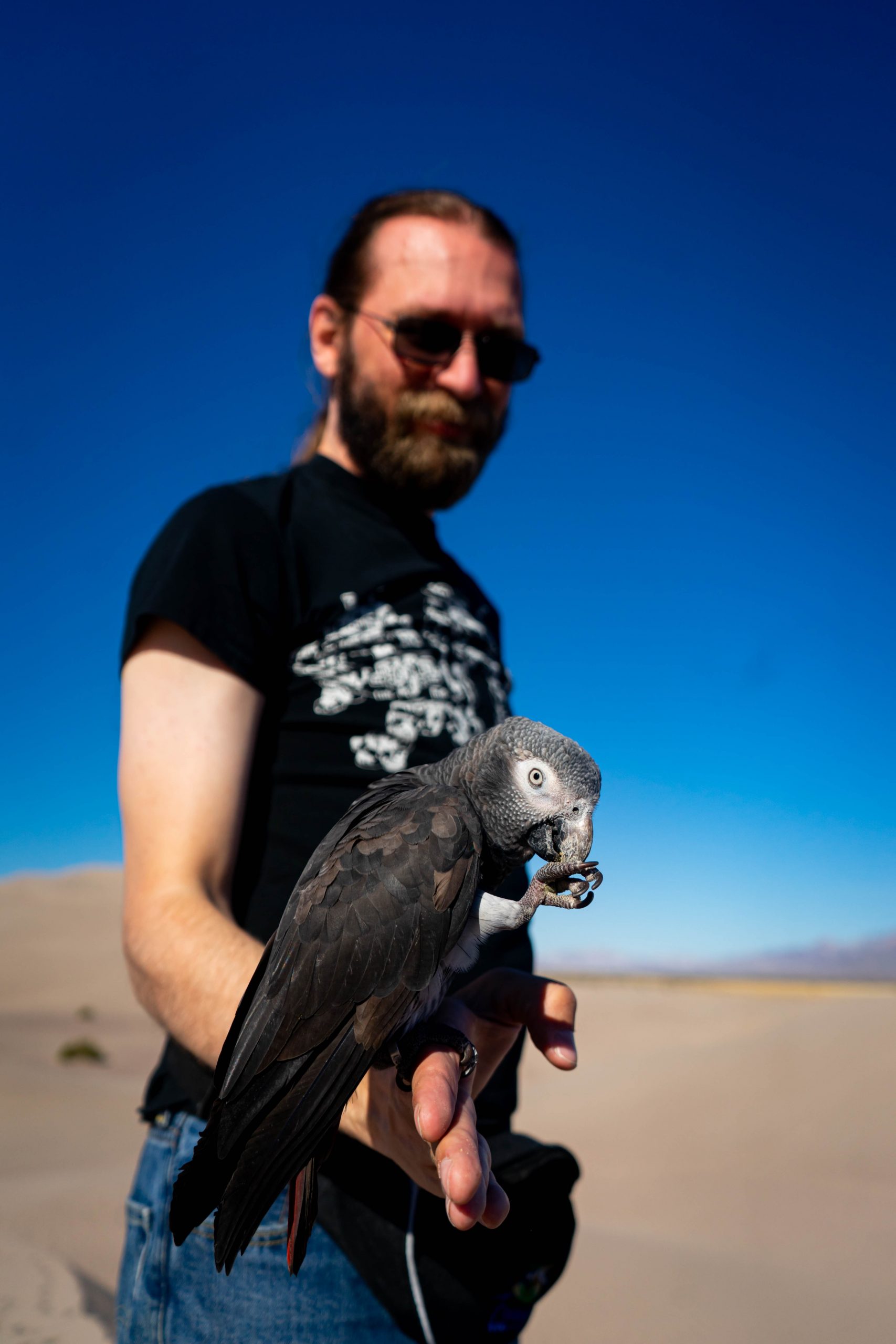 George holding bird while it cleans its claws