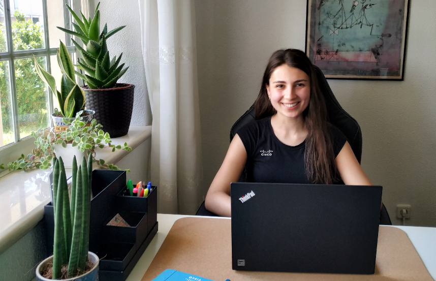 Ines working on laptop at her desk.