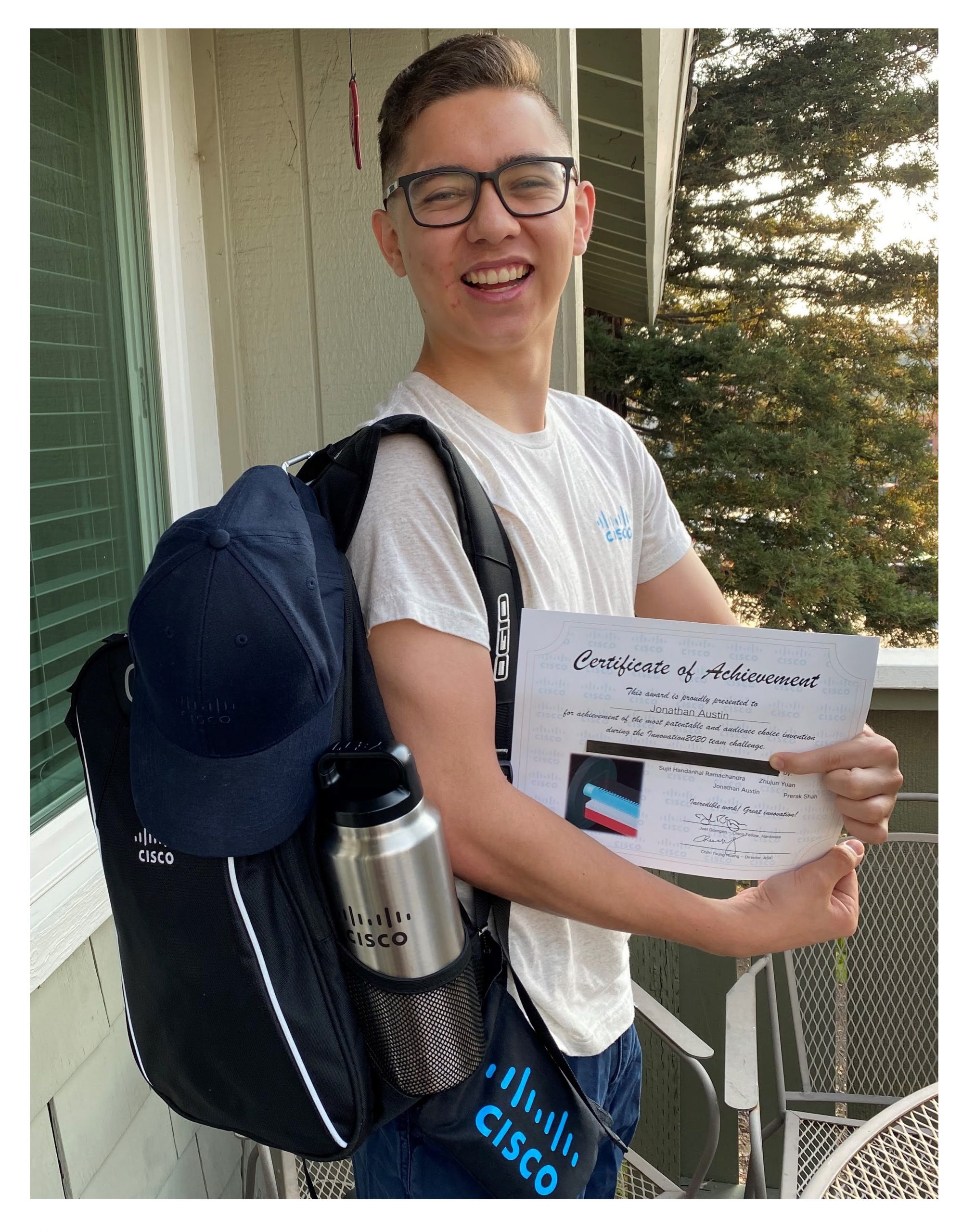Jonathan posing in Cisco gear with a certificate of achievement.