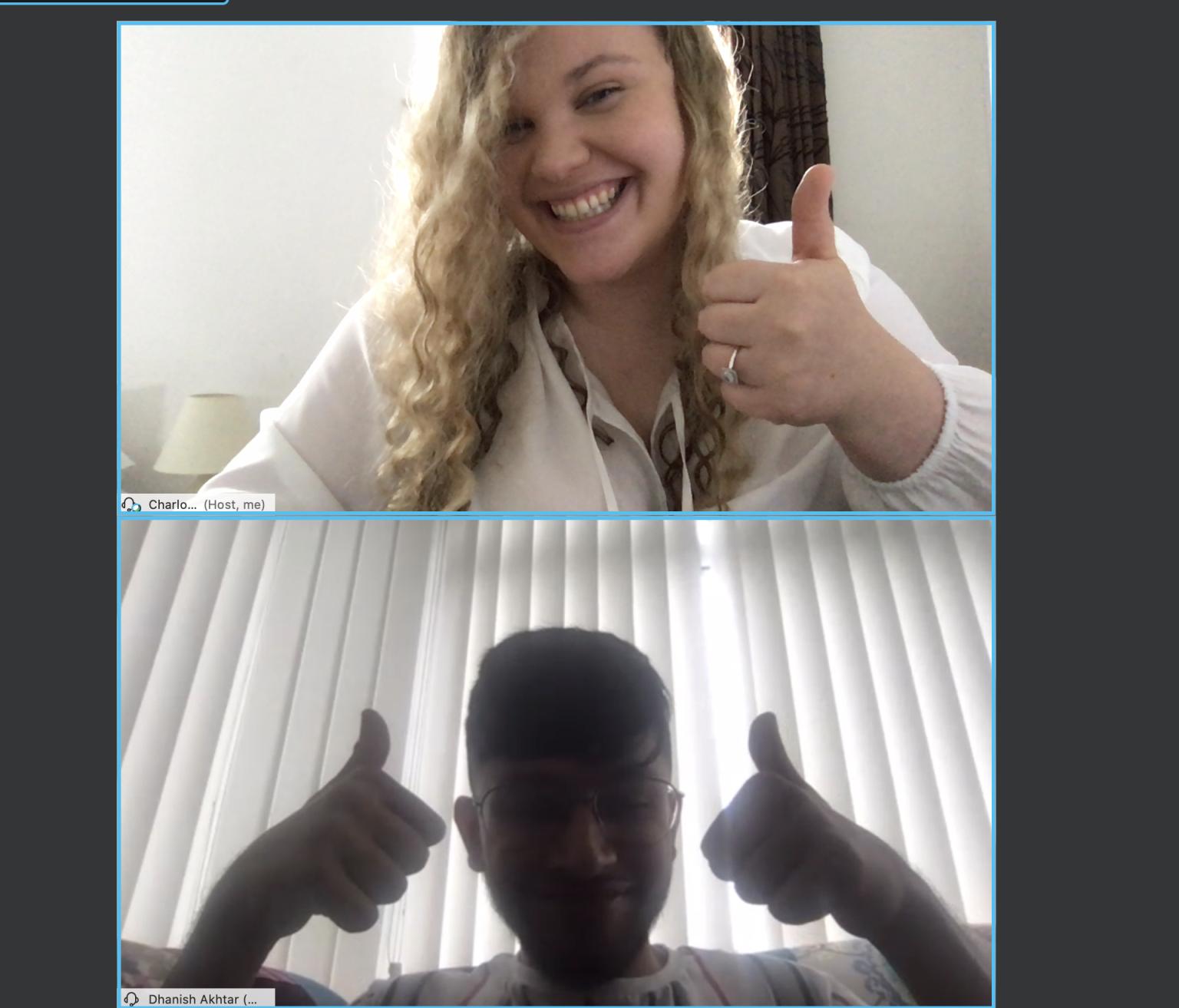 Charlotte and a colleague give a "thumbs up" over Webex.