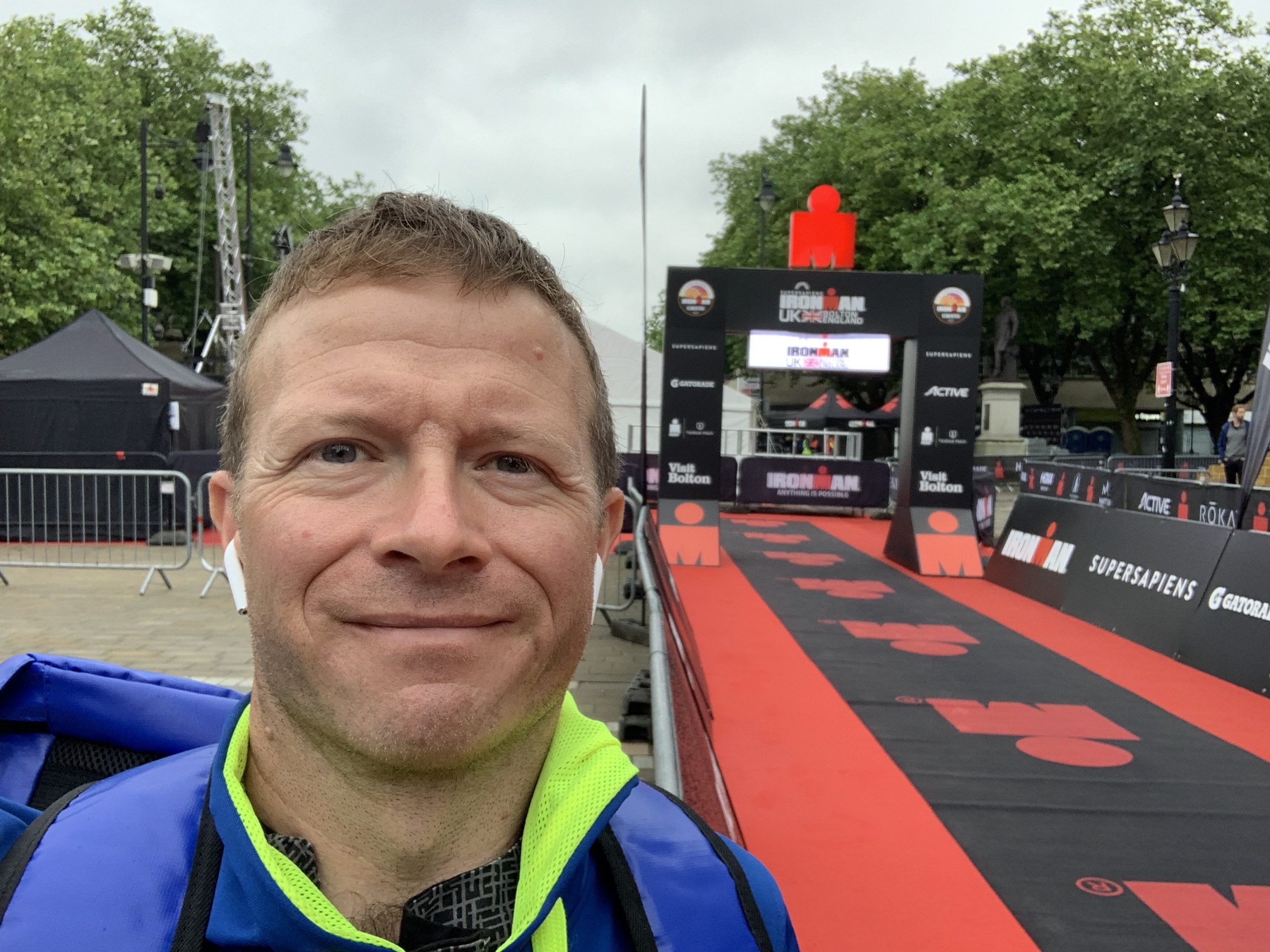 Mat taking a selfie in front of the Iron Man race finish line. 