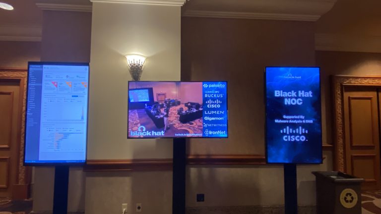 Monitors displaying sponsors at Black Hat
