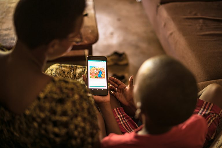 Parent reading to child through NABU's app