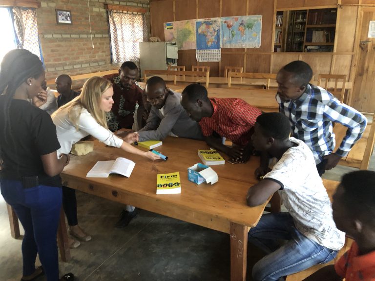 A woman showing a group of people an app on a phone