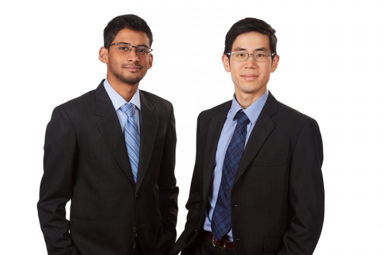 Two young men wearing business suits