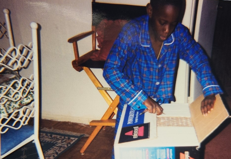 A young boy opening up a vacuum cleaner