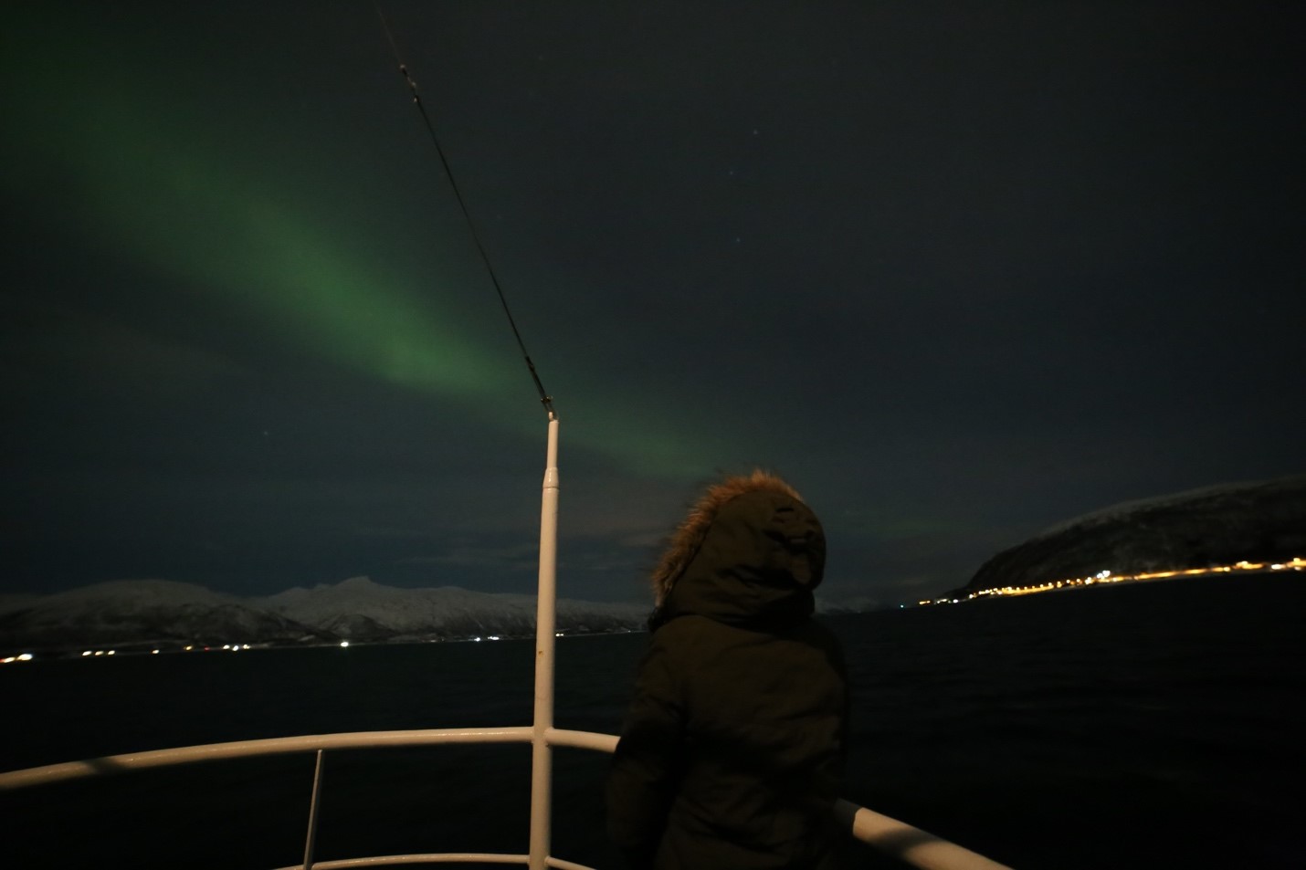 Miriam on a boat overlooking the Northern Lights.