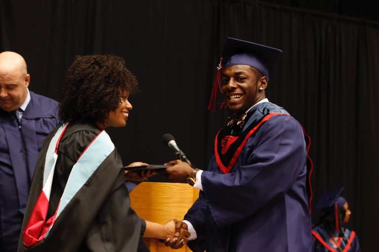 Kirkland accepting his diploma at graduation.