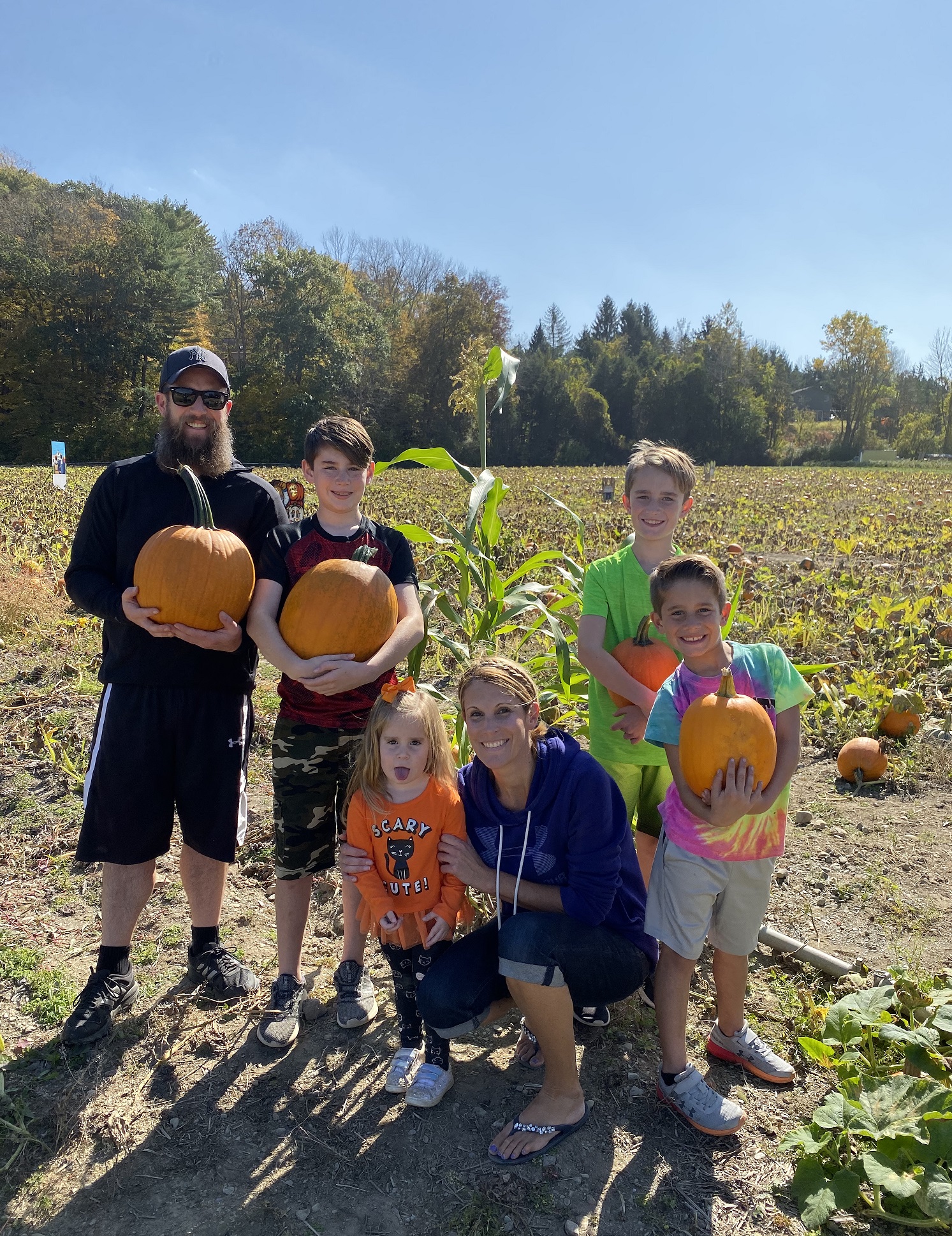 Chris and his family picking pumpkins.