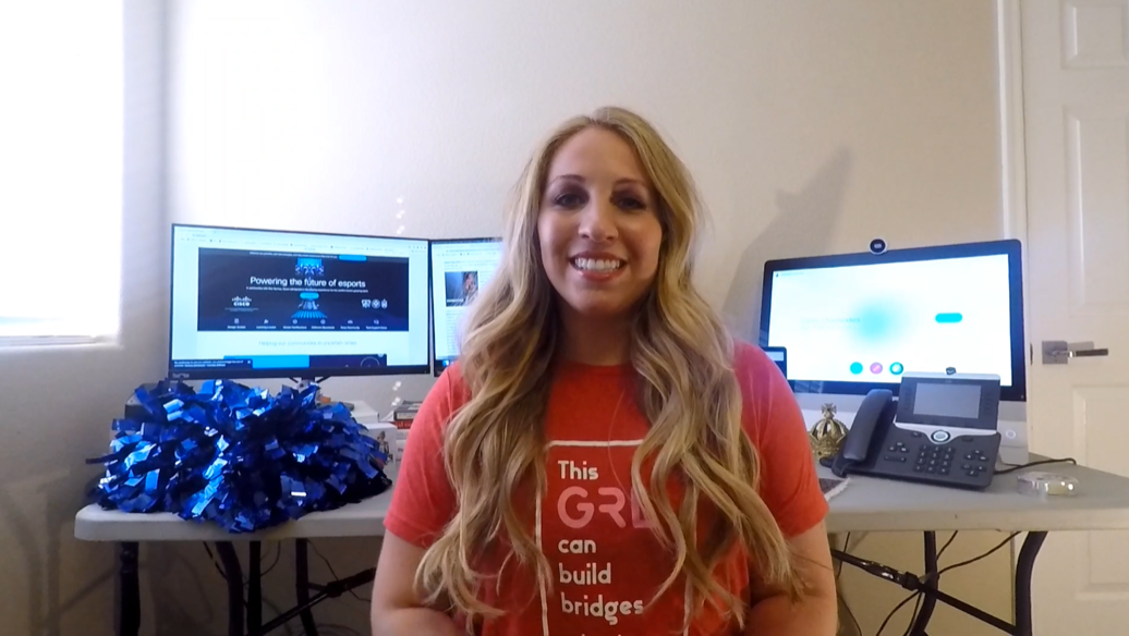 Samantha sits in from of multiple monitors in "This girl can build bridges" tshirt.