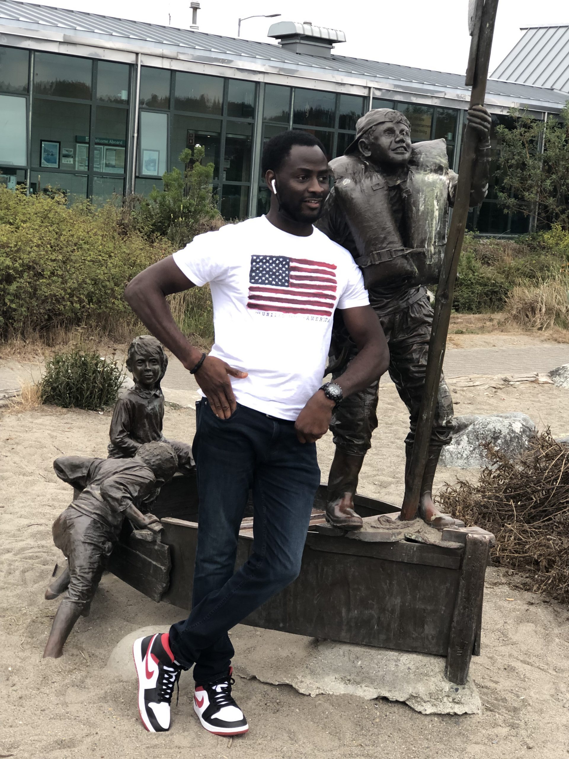 Stephen stands next to a statue.