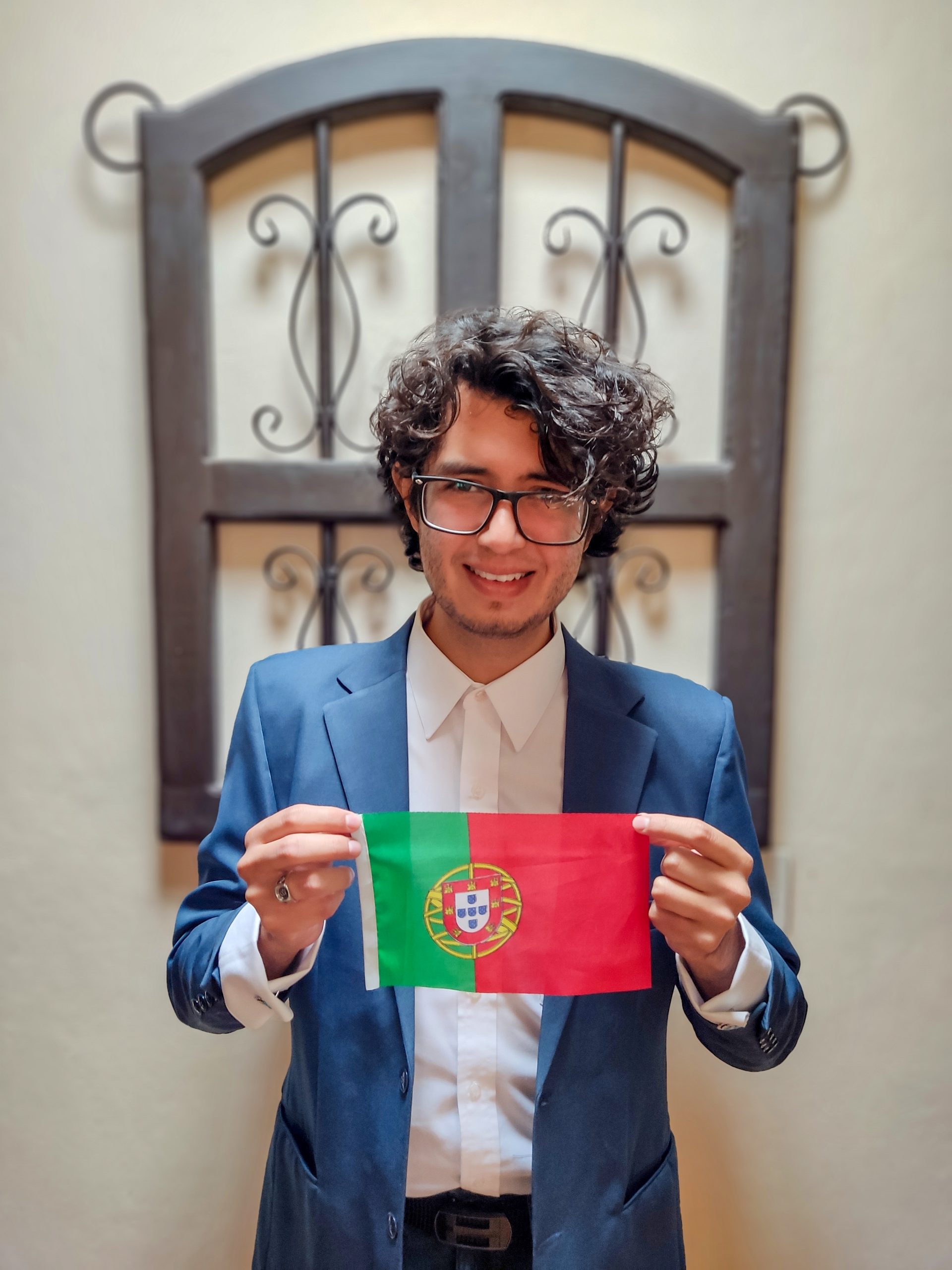 Alfonso holds out a flag in front of him.