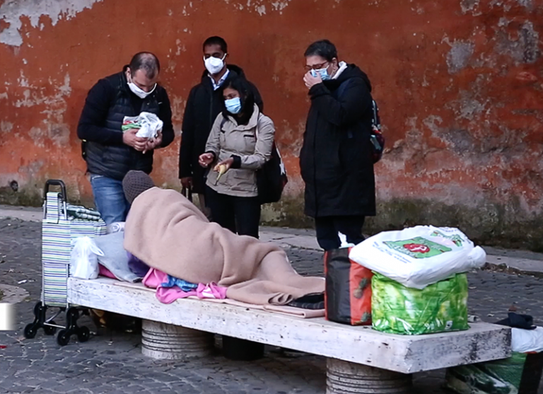 Community of Sant’Egidio volunteers interacting with a person experiencing homelessness